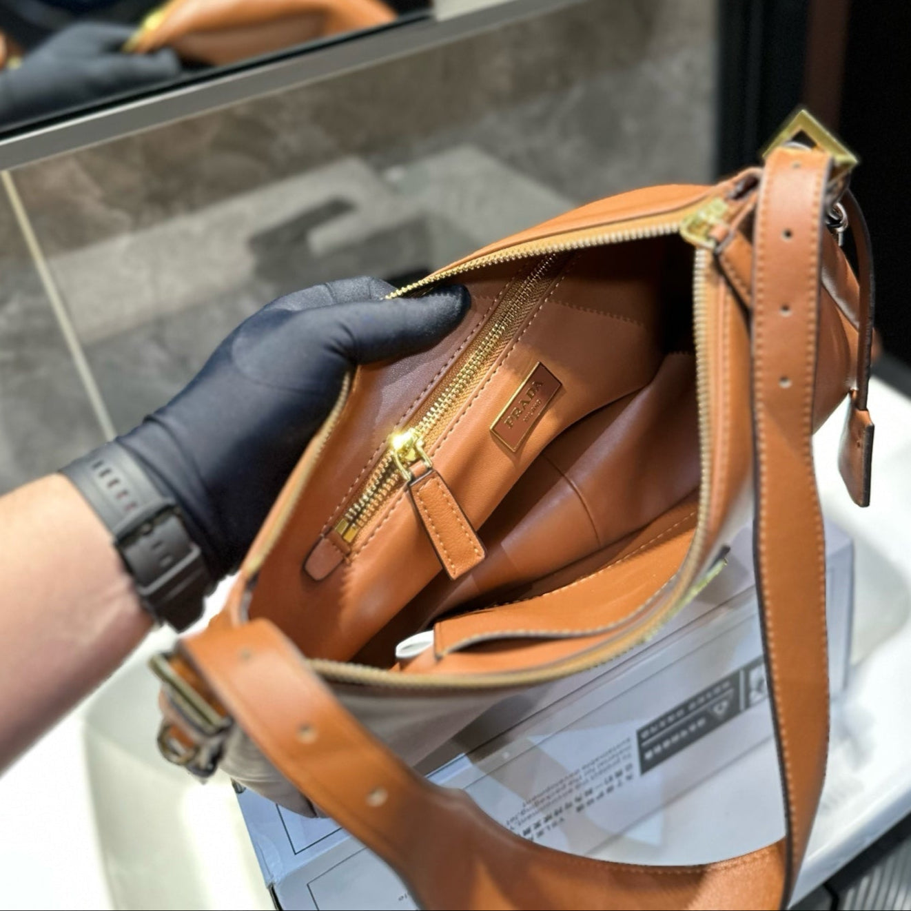 TRIANGLE LOGO HOBO BAG 34 IN BROWN SMOOTH CALFSKIN