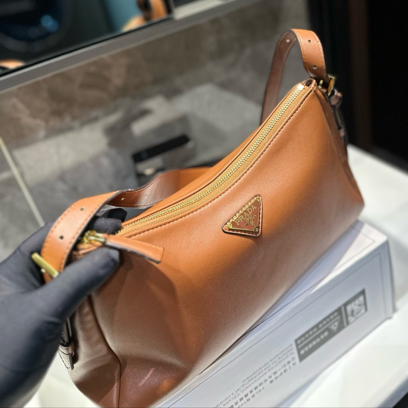 TRIANGLE LOGO HOBO BAG 34 IN BROWN SMOOTH CALFSKIN